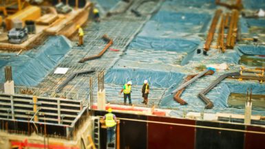 High-angle view of construction workers on a building site, engaging in construction work.